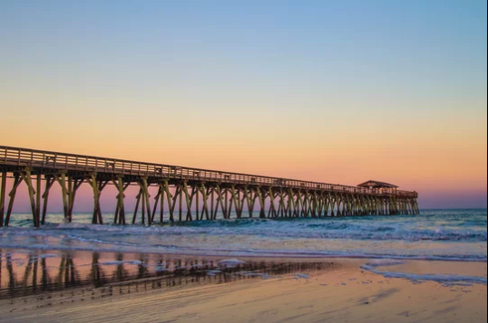 Myrtle Beach pier stretching into the ocean at sunset