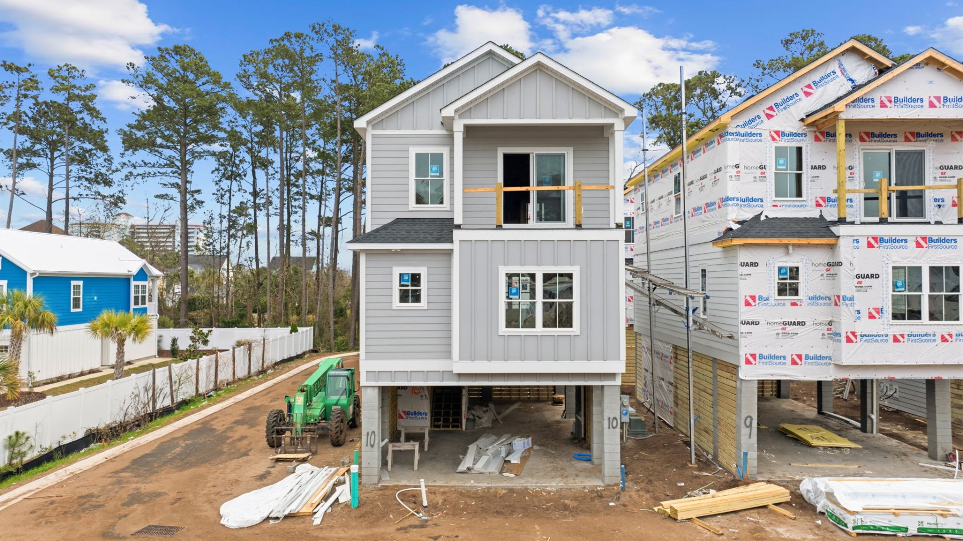 Three-story raised beach home with board-and-batten siding